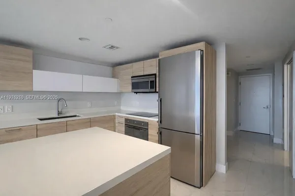 a kitchen with a refrigerator and a sink