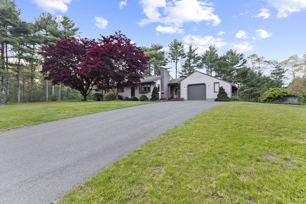 224 Snipatuit Road Rochester, MA 02770 - Photo 18 of 42 a front view of a house with a garden and trees