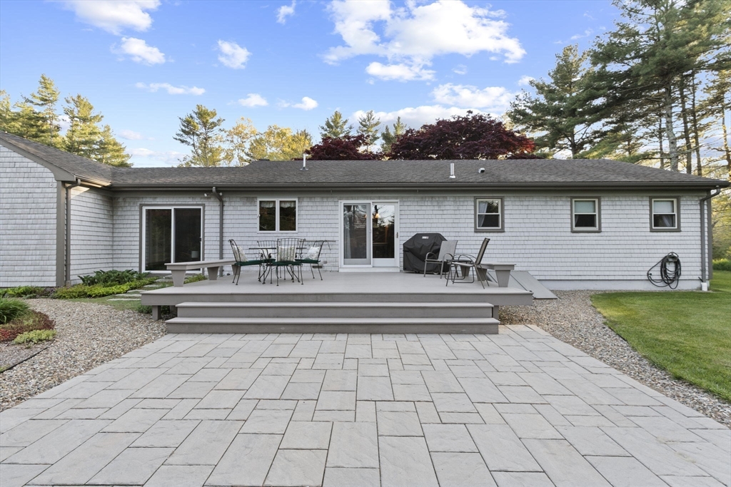 224 Snipatuit Road Rochester, MA 02770 - Photo 20 of 42 a view of a white house with a swimming pool and outdoor seating