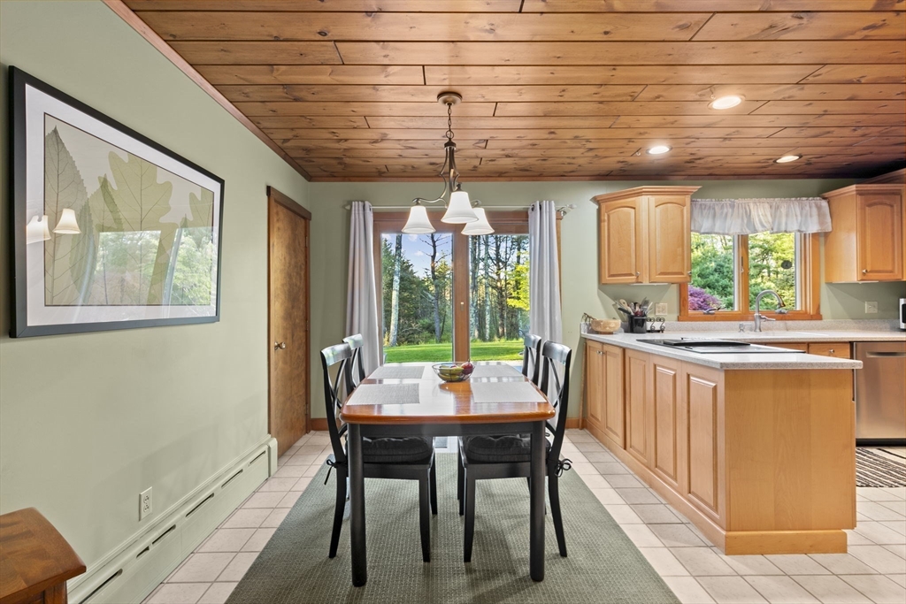 224 Snipatuit Road Rochester, MA 02770 - Photo 27 of 42 a dining room with furniture a chandelier and wooden floor