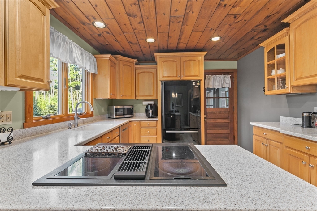 224 Snipatuit Road Rochester, MA 02770 - Photo 31 of 42 a kitchen with stainless steel appliances granite countertop a sink window and refrigerator