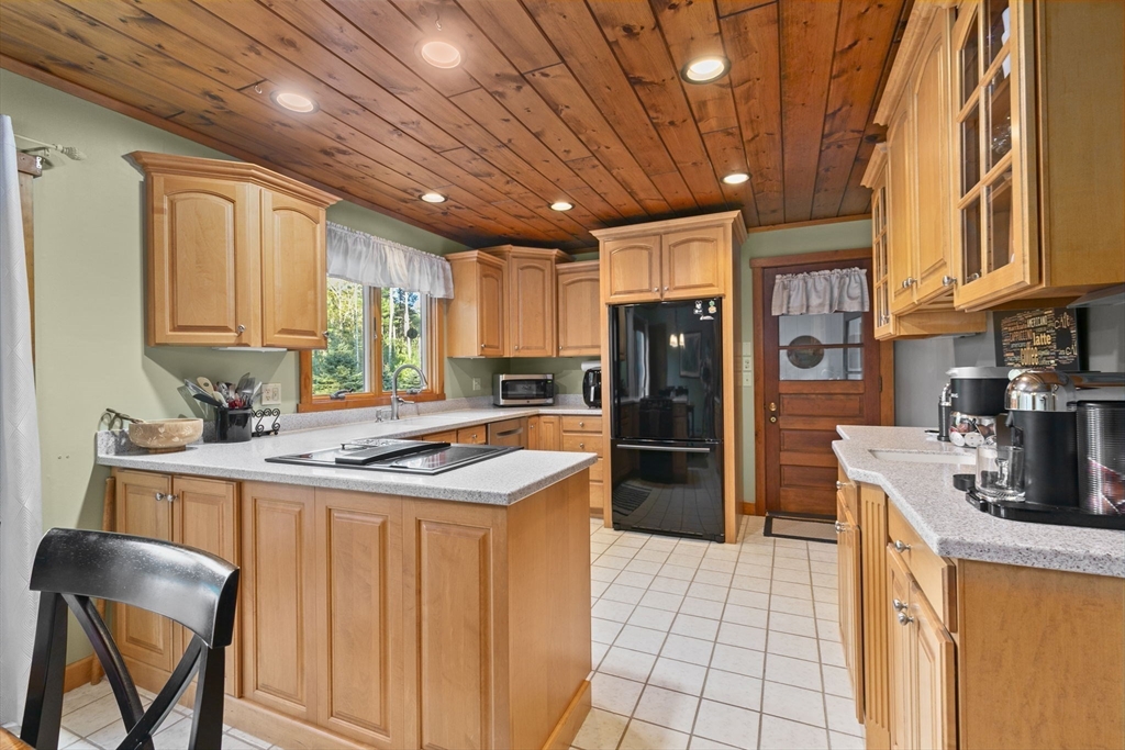 224 Snipatuit Road Rochester, MA 02770 - Photo 33 of 42 a kitchen with stainless steel appliances granite countertop a refrigerator a sink dishwasher a stove and white countertops with wooden floor