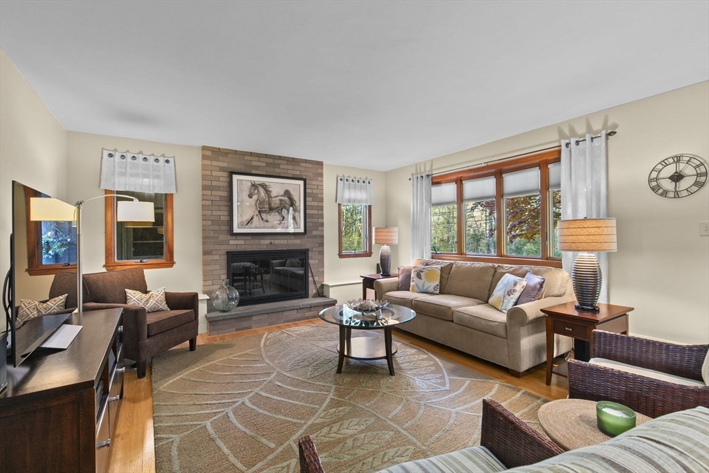 224 Snipatuit Road Rochester, MA 02770 - Photo 6 of 42 a living room with fireplace furniture and a large window