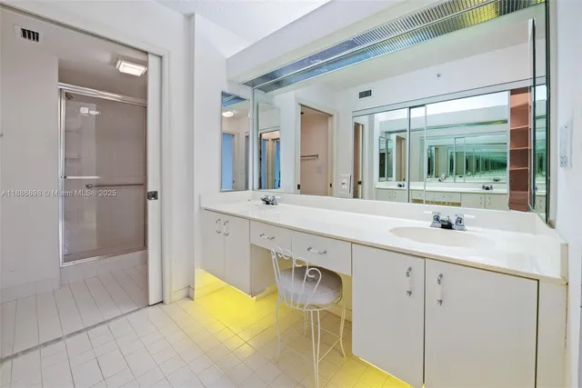 a bathroom with a double vanity sink and mirror