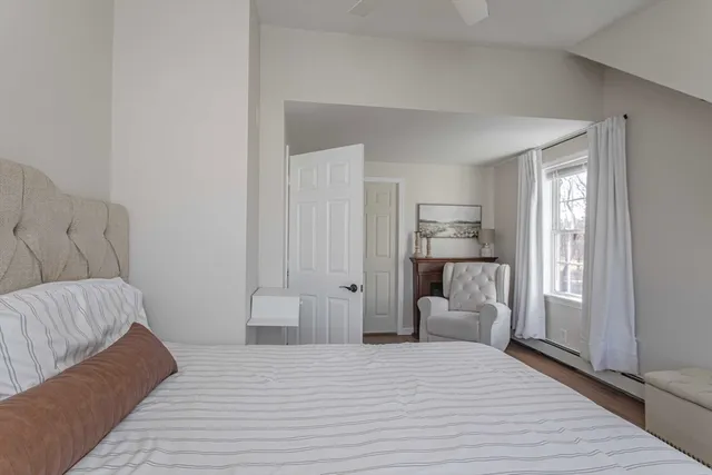 a room with a bed and a couch next to a window