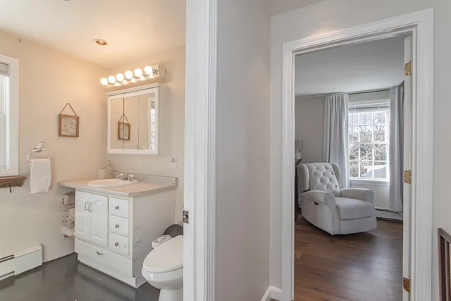 a bathroom with a sink a vanity and a large mirror