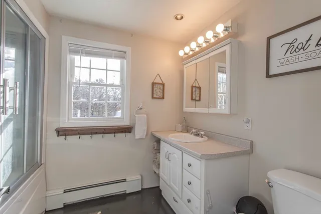 a white toilet sitting next to a bathroom sink