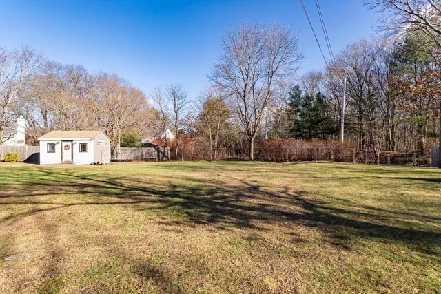 a view of a patio with table and chairs with wooden floor and fence
