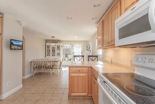 a kitchen with stainless steel appliances granite countertop a sink and a stove top oven