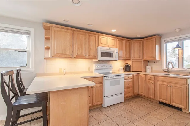 a kitchen with white cabinets and sink