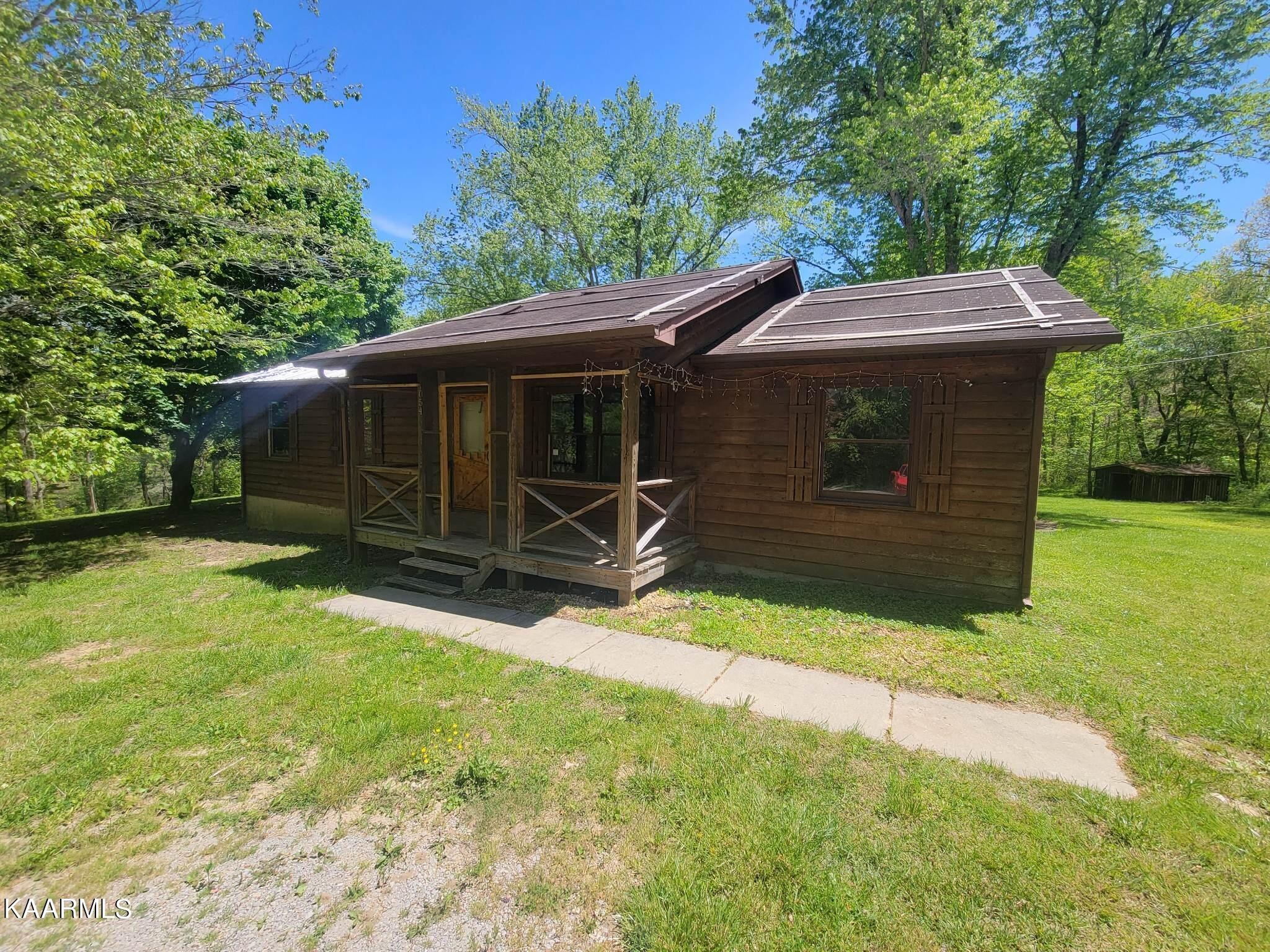 1054 Franklin Loop Clarkrange, TN 38553 - Photo 27 of 35 a view of backyard with barn and a large cactus tree