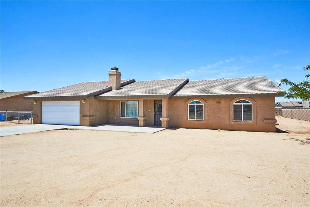 21072 Rambling Road Apple Valley, CA 92308 - Photo 1 of 1 a front view of a house with a yard