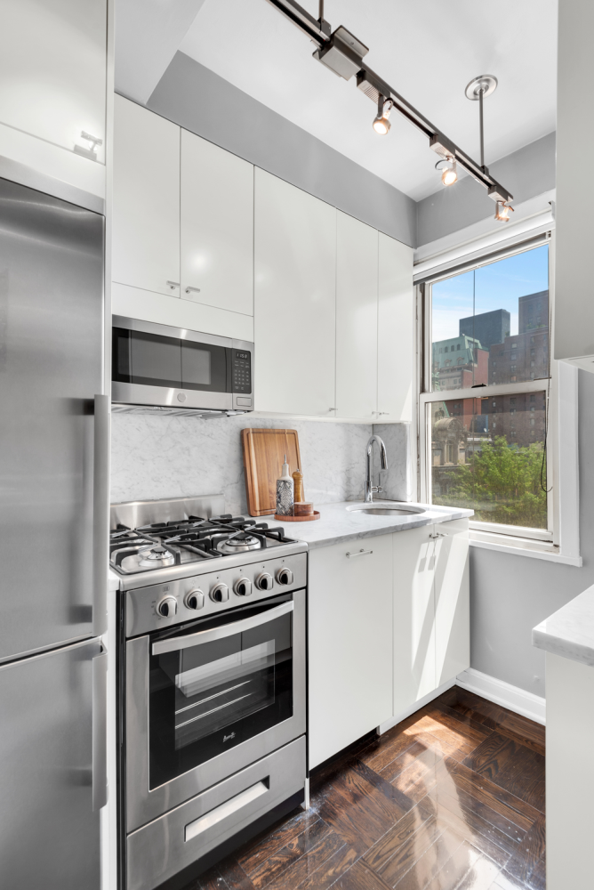 220 Madison Avenue, Unit 8H Manhattan, NY 10016 - Photo 4 of 10 a kitchen with granite countertop a stove and a sink