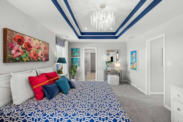 a bedroom with furniture and a chandelier