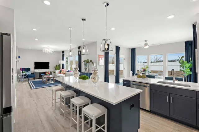 a large kitchen with a table and chairs