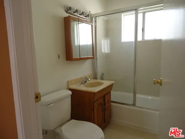 a bathroom with a sink toilet vanity and tub