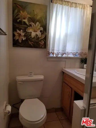 a white toilet sitting next to a shower curtain