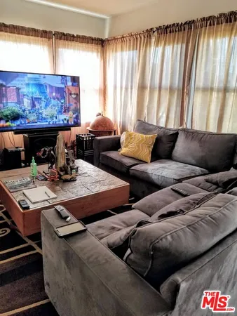 a living room with furniture and a lamp