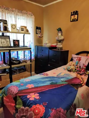 a bedroom with a bed and dresser