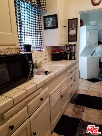 a kitchen with a sink and a stove top oven