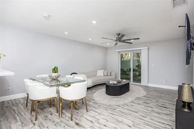 a living room with furniture a window and a potted plant