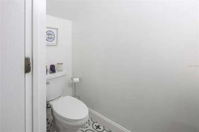 a white toilet sitting next to a shower