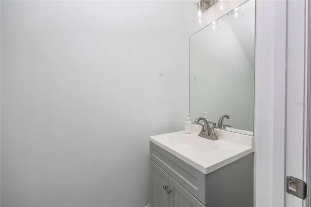 a bathroom with a sink and mirror