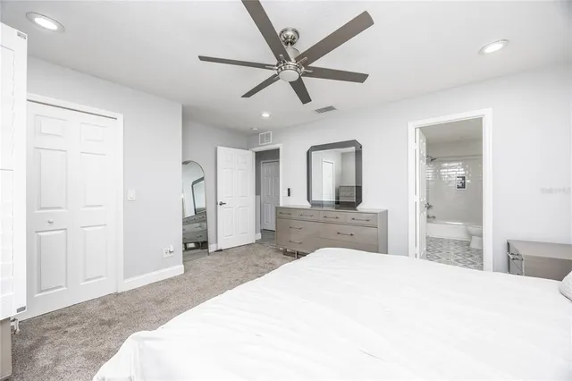 a bedroom with a large bed and closet