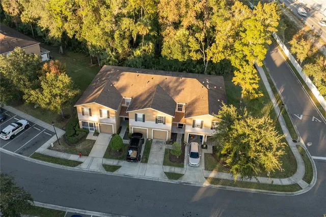 an aerial view of residential houses with outdoor space