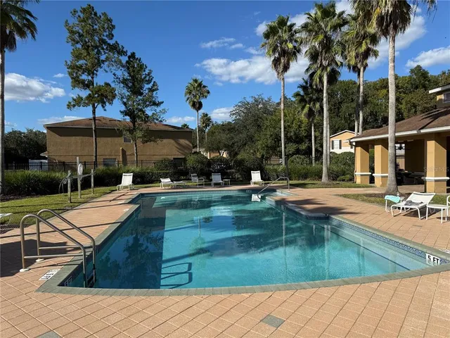 a swimming pool with outdoor seating and yard