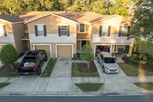 a view of a white house with a yard and tv