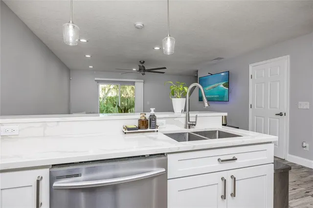 a kitchen with kitchen island a sink and a window