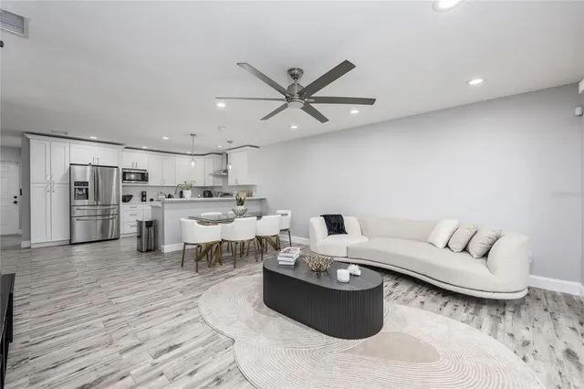 a living room with furniture and kitchen view
