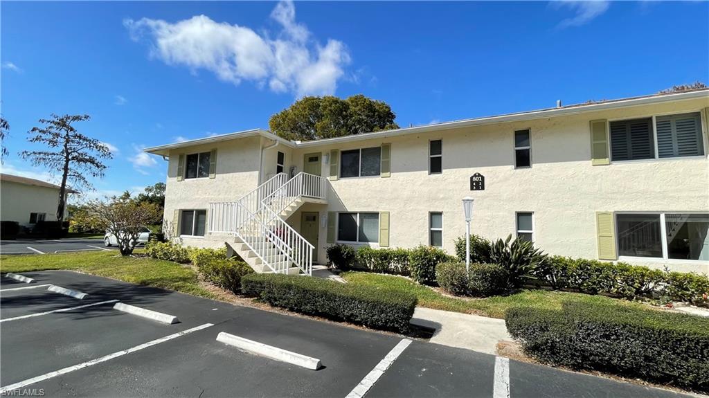 801 Teryl Road, Unit 4 Naples, FL 34112 - Photo 14 of 19 View of apartment building / complex featuring stairway and uncovered parking