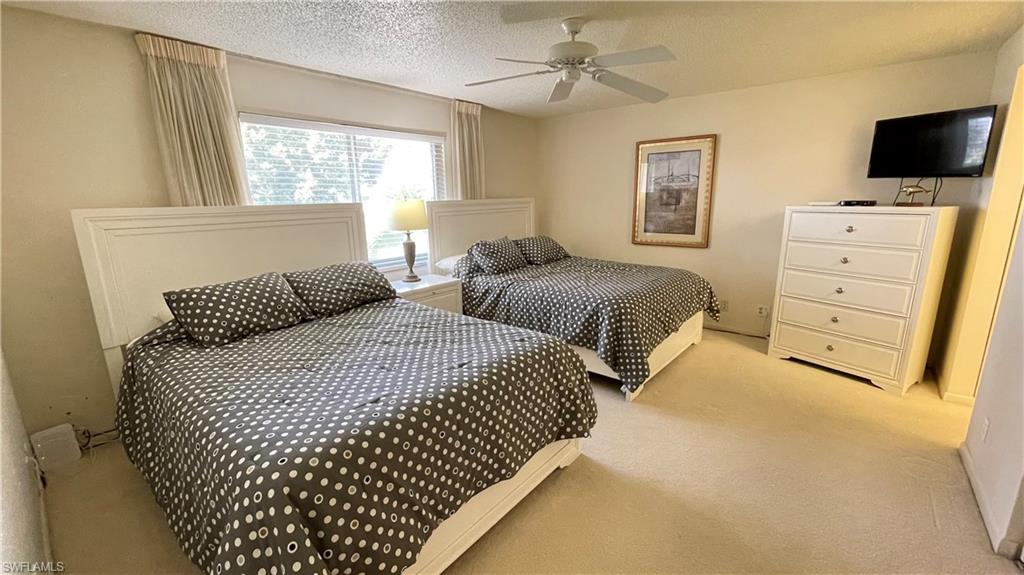 801 Teryl Road, Unit 4 Naples, FL 34112 - Photo 4 of 19 Carpeted bedroom with ceiling fan