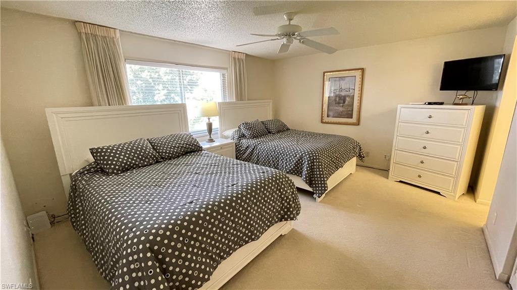 801 Teryl Road, Unit 4 Naples, FL 34112 - Photo 7 of 19 Bedroom featuring carpet floors, and a ceiling fan