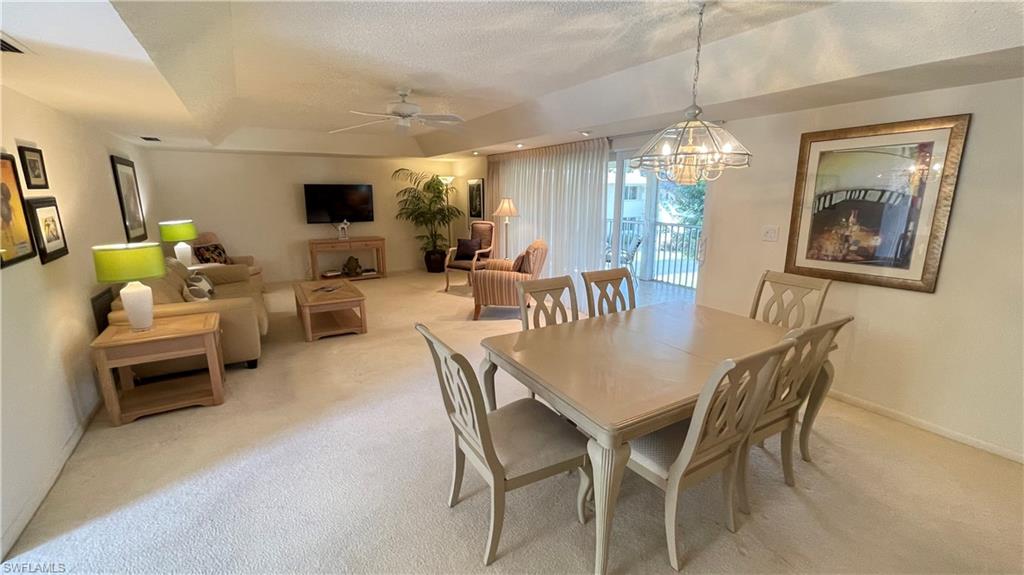 801 Teryl Road, Unit 4 Naples, FL 34112 - Photo 9 of 19 Dining space featuring light carpet, a ceiling fan, and a raised ceiling
