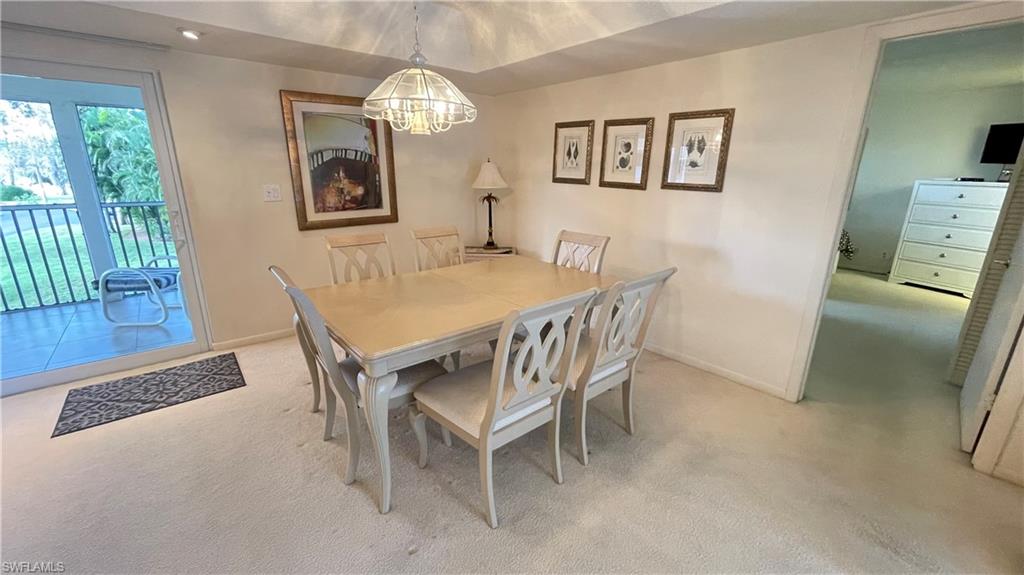 801 Teryl Road, Unit 4 Naples, FL 34112 - Photo 10 of 19 Carpeted dining area with baseboards and suspended lighting