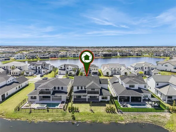 a aerial view of a house with swimming pool and lake view