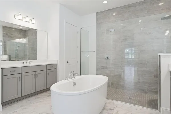 a bathroom with a granite countertop sink toilet a mirror and shower