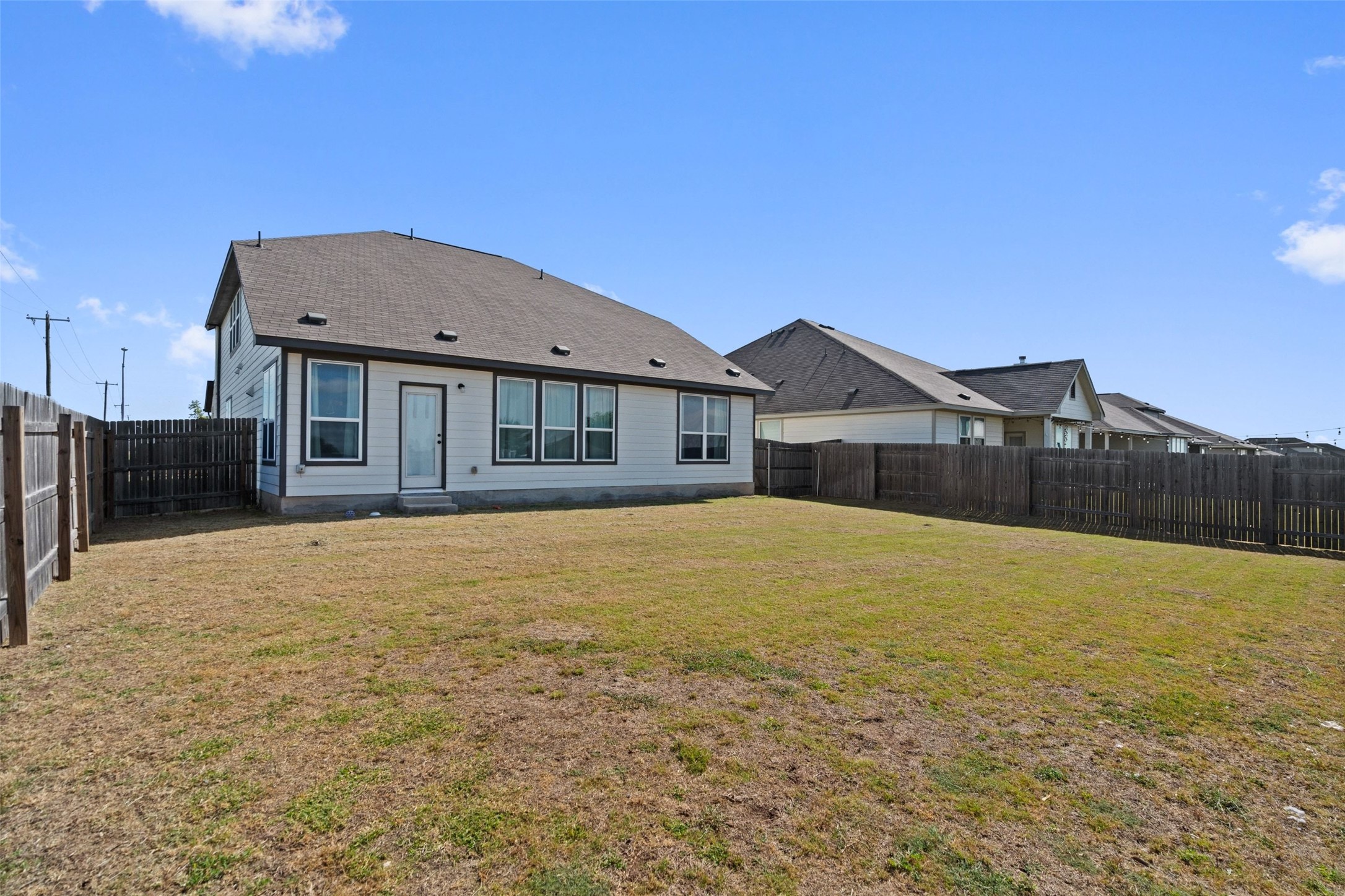 100 Panico Road Hutto, TX 78634 - Photo 28 of 28 A spacious, fenced backyard offers ample room for outdoor activities.