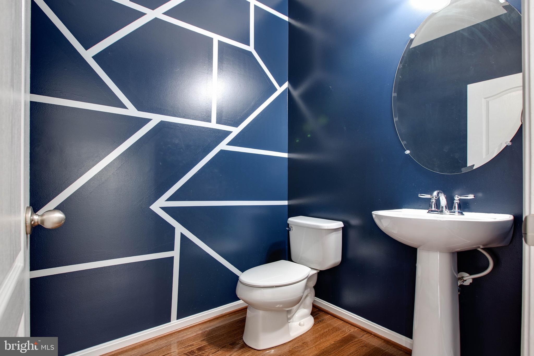 7926 Silver Oak Road Hanover, MD 21076 - Photo 11 of 44 a bathroom with a toilet a sink and mirror