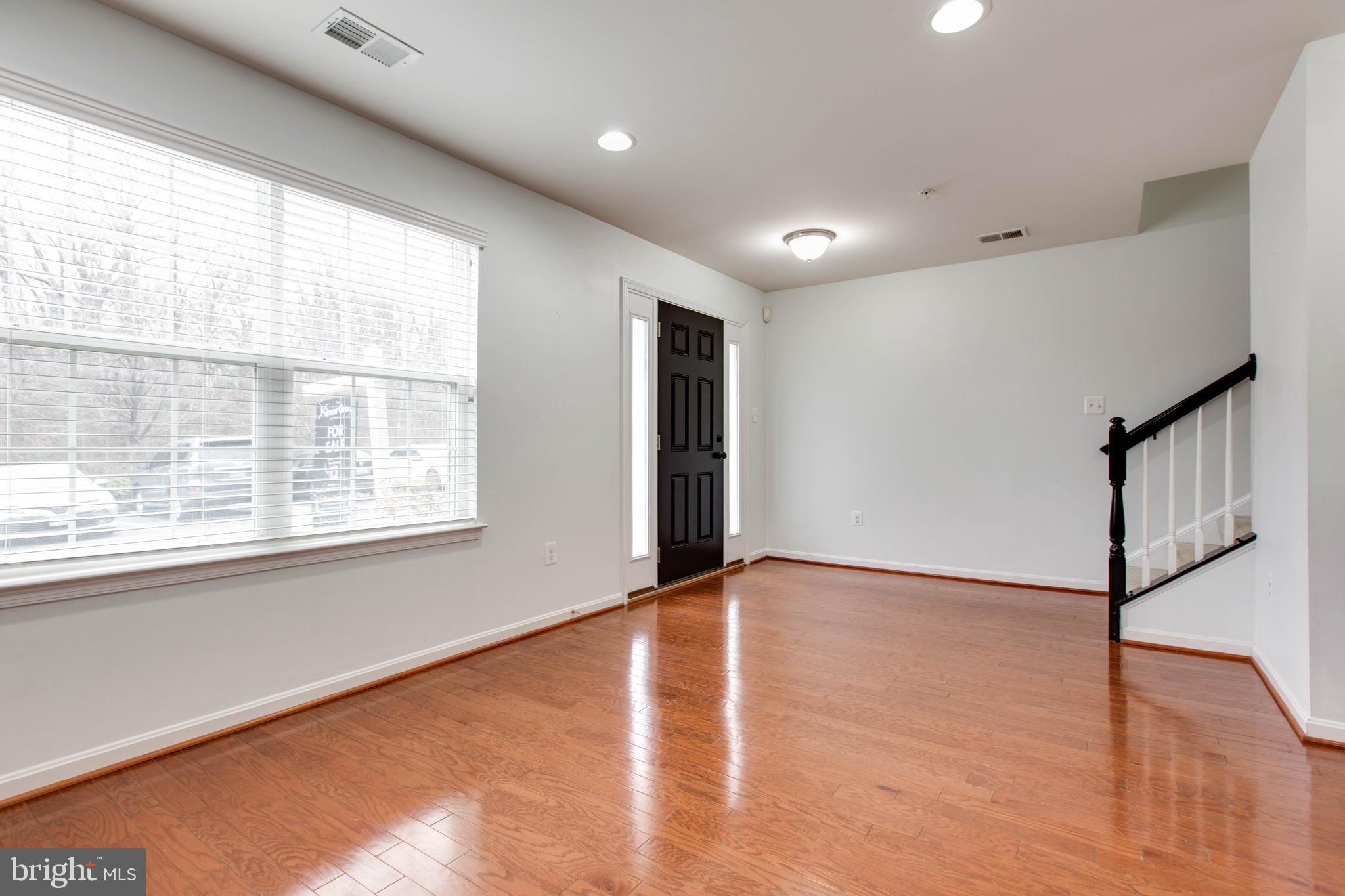 7926 Silver Oak Road Hanover, MD 21076 - Photo 38 of 44 a view of an empty room with wooden floor and a window