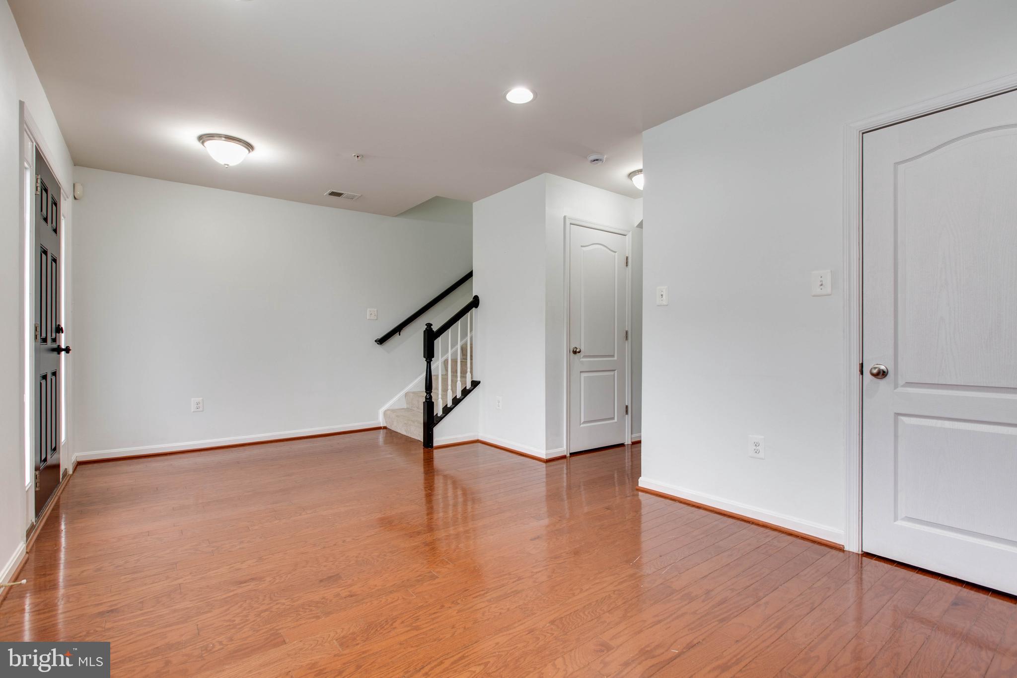7926 Silver Oak Road Hanover, MD 21076 - Photo 40 of 44 a view of an empty room with wooden floor