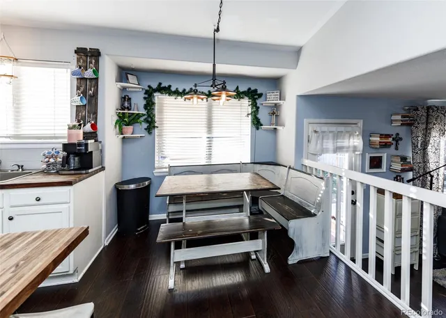 a living room with furniture windows and wooden floor