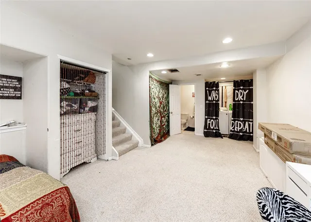 a view of an empty room with closet and windows