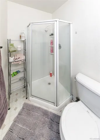 a bathroom with a toilet and a shower