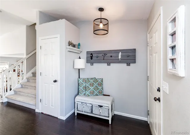 a view of a hallway with wooden floor and staircase