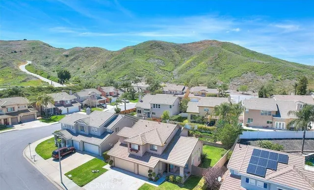 an aerial view of a house with a big yard