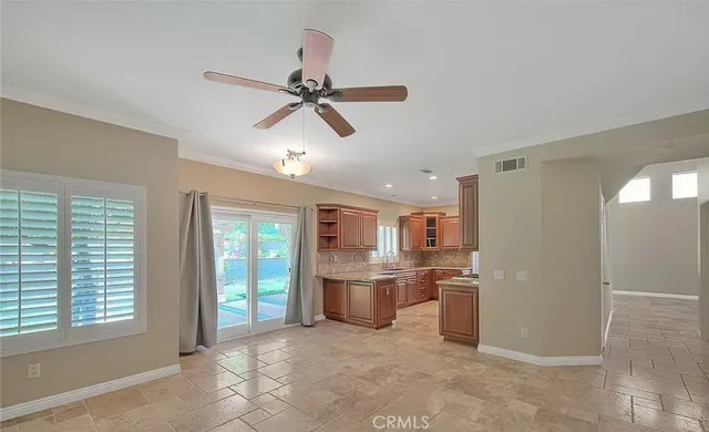 a open kitchen with stainless steel appliances granite countertop a refrigerator and a sink